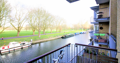 TO LET: Spacious two bedroom apartment with balcony overlooking the canal and gated parking!